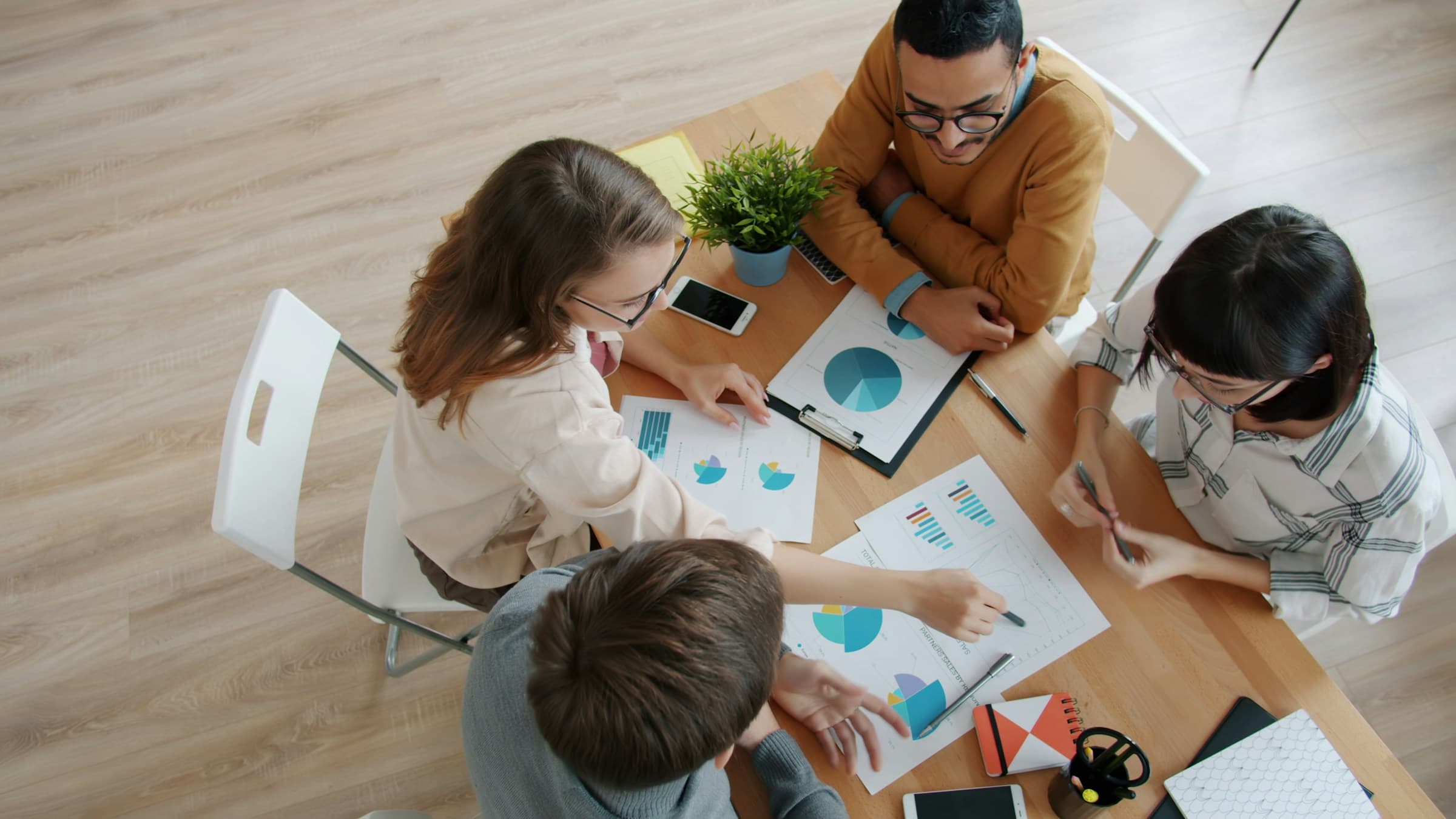 A group collaborating together around a table.