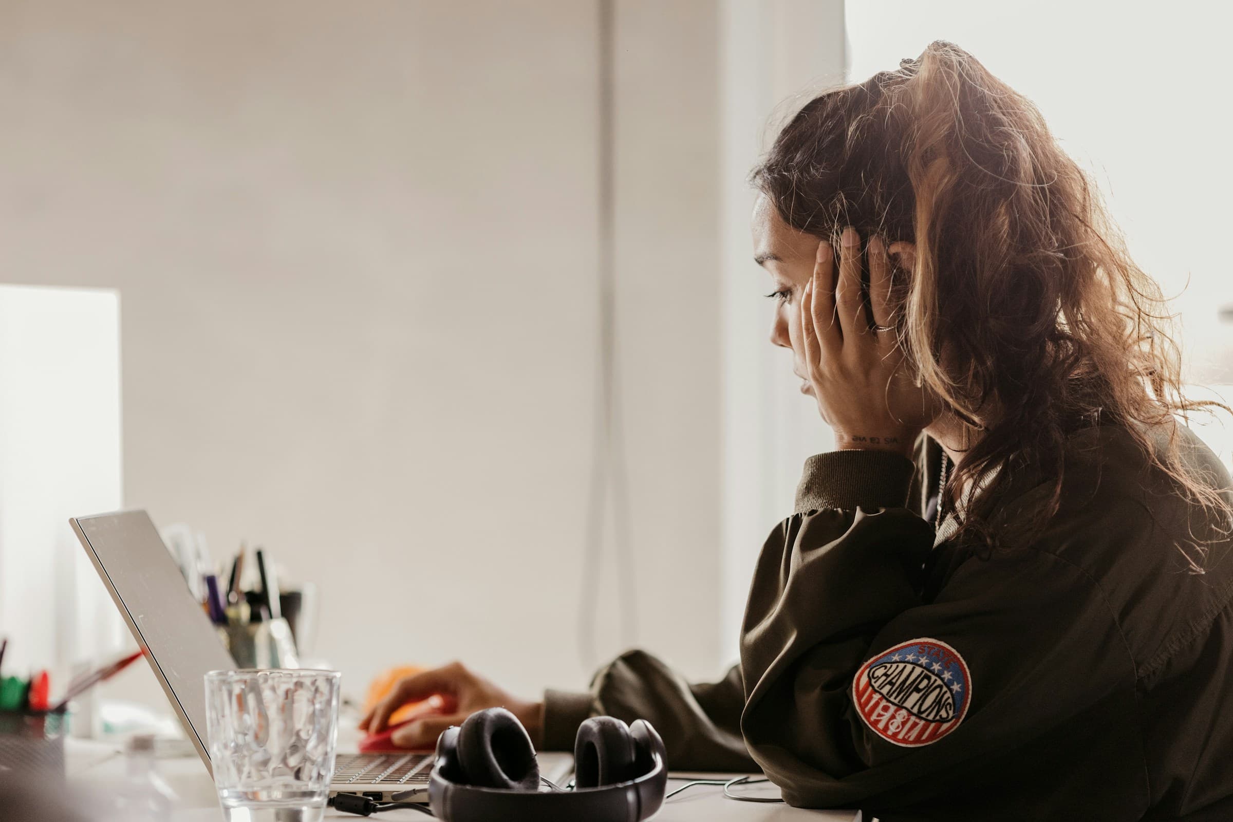 Person feeling overwhelmed while working on a laptop.